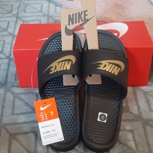Black and gold Nike slides